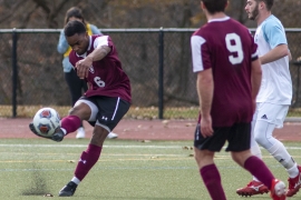 male soccer player kicks ball 